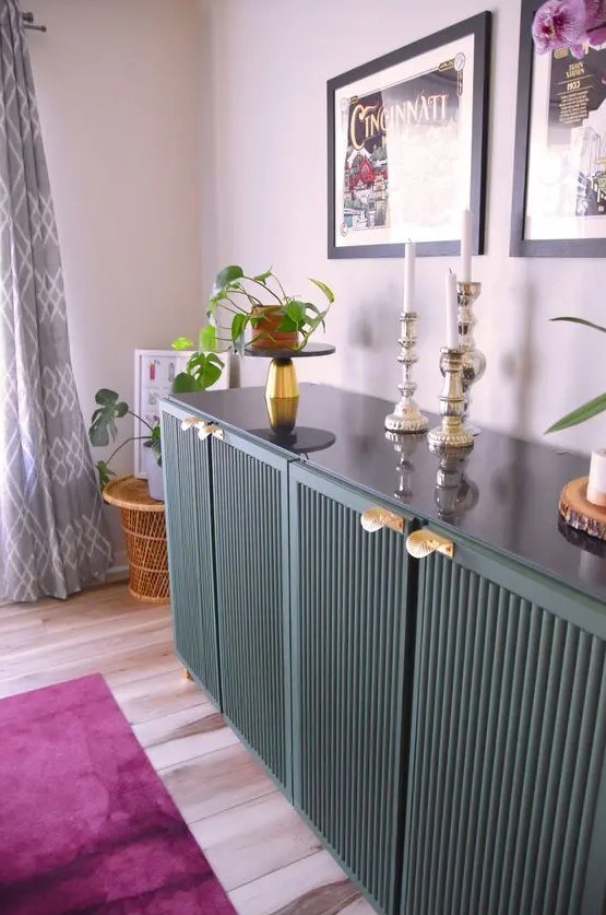 a forest green fluted IVAR sideboard with gold handles, decor, potted plants and candles is a lovely idea for a modern space