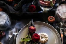 17 a refined vampire Halloween tablescape with black textiles, white porcelain, black cutlery and some spooky food, red blooms
