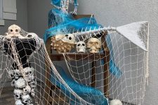 17 a tropical to mermaid outdoor Halloween decoration of a skeleton mermaid, a fishnet and skulls can be placed on your porch