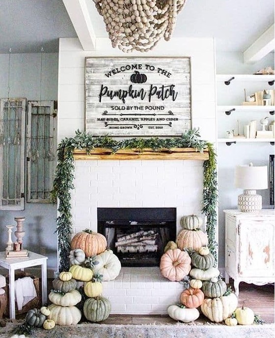 a greenery garland and stacks of natural pumpkins will make your fireplace more fall like at once