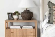 18 a large oak fluted nightstand with coffee books, a table lamp, potted plants is a trendy and edgy idea for a bedroom