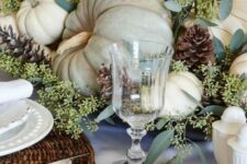 18 a neutral rustic table setting with woven placemats, white plates and napkins, all-natural pumpkins, greenery and pinecones