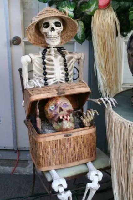 a skeleton with a chest and a dead head inside is a bold and catchy outdoor Halloween decoration