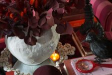 24 exquisite vampire Halloween decor with a burgundy velvet skull, burgundy and red dried foliage and a blackbird