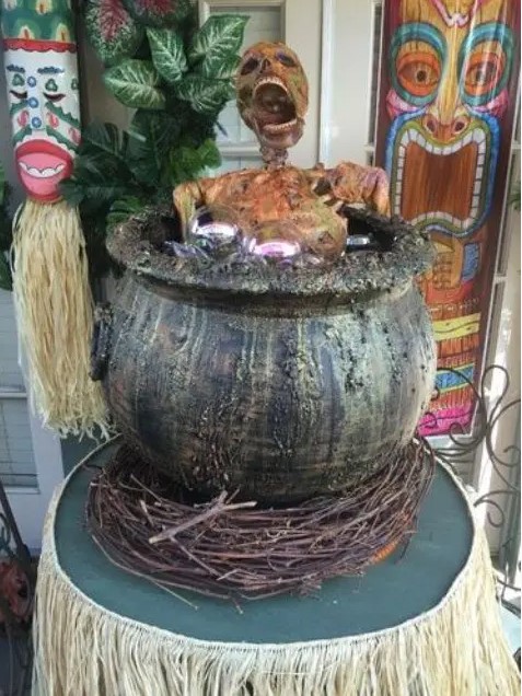 tiki party done right - a skeleton cooked in a cauldron is a cool idea for a tropical Halloween