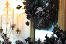 25 elegant and frightfully chic Halloween decor with black foliage and grasses on the mantel and a matching wreath