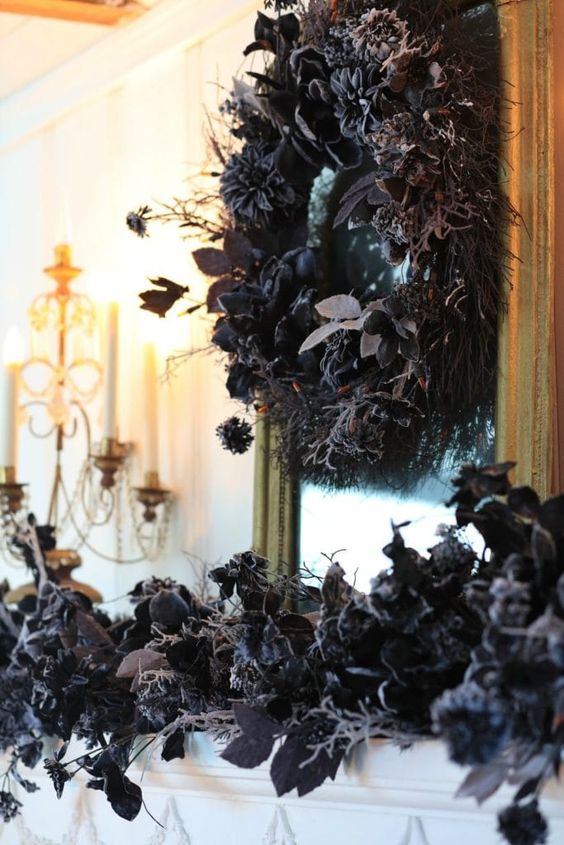 elegant and frightfully chic Halloween decor with black foliage and grasses on the mantel and a matching wreath