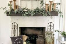 26 a neutral fall fireplace wwith shabby chic churns, white pumpkins and wheat, wooden candle holders and much greenery