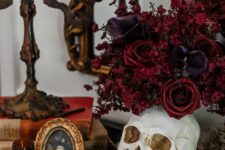 26 refined Halloween vampire decor with a skull, deep purple callas and red roses, a witch portrait and vintage candelholders