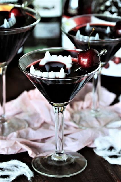 a bloody cocktail with jaws and a cherry is a stunning and bold idea for a vampire party