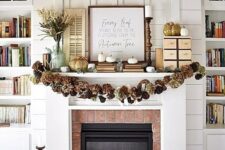 30 a rustic fall mantel with a pinecone and hydrangea garland, white pumpkins and faux porcelain ones, a branch arrangement in a bucket
