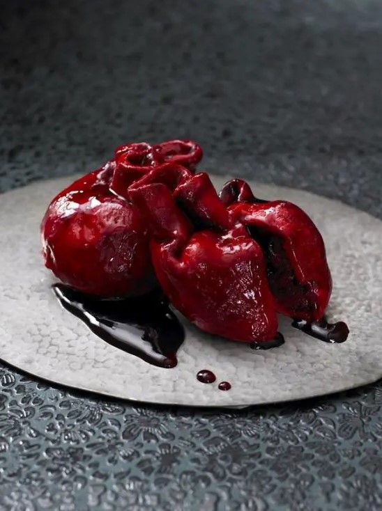 a bloody human heart cake is a bold and scary idea of a Halloween party dessert that you can order to impress everyone