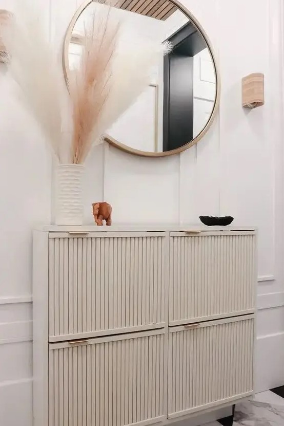 a super chic IKEA Stall hack with fluted doors and gold handles is a perfect fit for this refined entryway