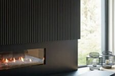 32 a minimalist black fireplace with a fluted surround only on top is a stylish and elegant solution for a contemporary space