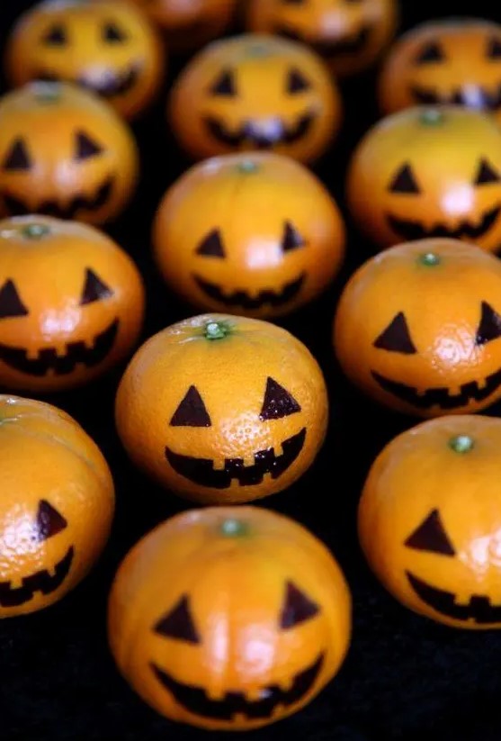 mandarins decorated as pumpkin jack-o-lanterns will excite your guests