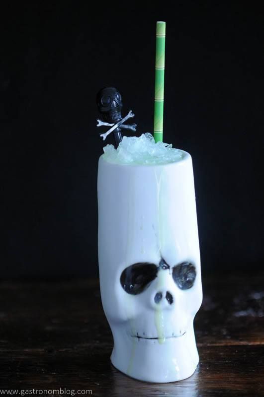 a tropical Halloween cocktail served in a zombie head is a cool and fun solution for your party