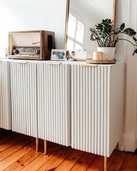 a white IKEA Ivar hack with fluting as a media console with storage space is a stylish idea for a modern space