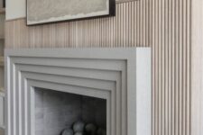 35 a modern fireplace with a framed surround and a fluted one is a stylish idea for a modern space, it looks chic and cool