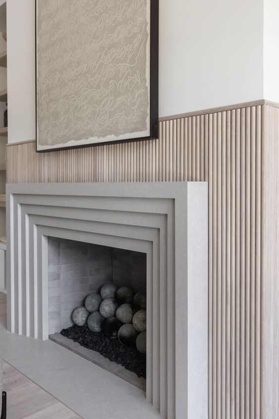 a modern fireplace with a framed surround and a fluted one is a stylish idea for a modern space, it looks chic and cool