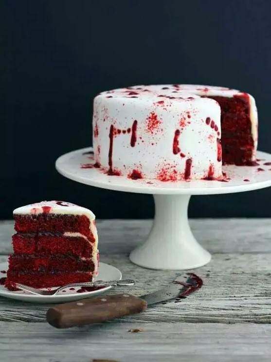 a vampire cake in deep red and with blood on the white frosting is a great idea for a Halloween party with vampire style