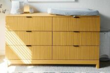 35 a yellow IKEA dresser done with fluting as a changing table for a nursery is a lovely and chic solution