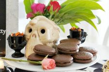 35 tropical Halloween with chocolate pies, fresh fruit, greenery and blooms in a skull vase