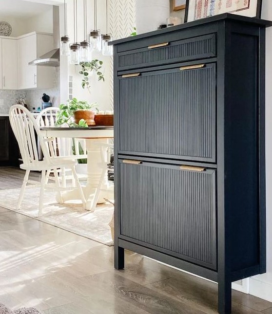 an elegant black IKEA Hemnes shoe cabinet hack with fluted panels and gold handles is a stylish idea
