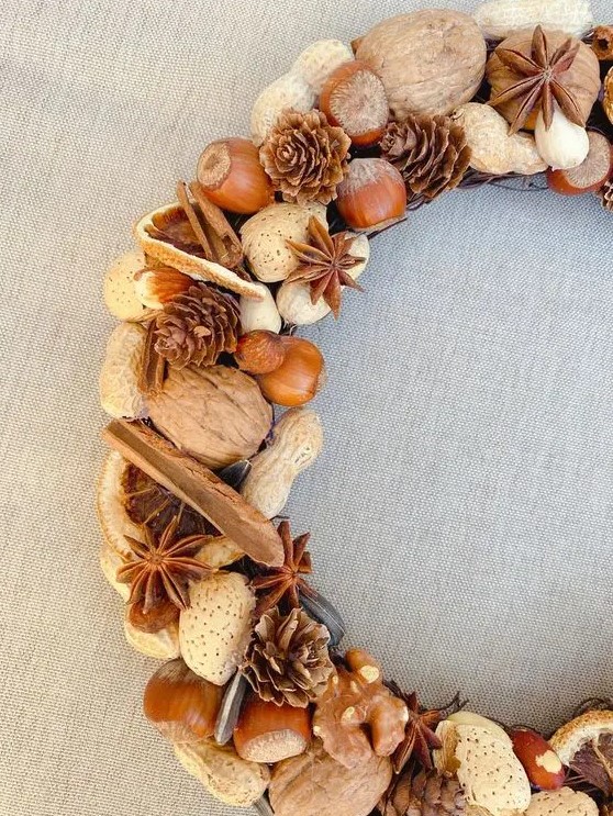 a rustic farmhouse wreath with nuts of various kinds, pinecones, cinnamon bark and lots of other stuff is a lovely harvest inspired idea