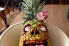 37 real pineapple, cherry Laffy Taffy tongue, black raspberry jam blood and custom undead eyes comprise a pineapple zombie face