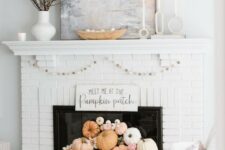 39 a white brick fireplace with white and pastel pumpkins, blooms, a garland and some branches on the mantel is great for the fall