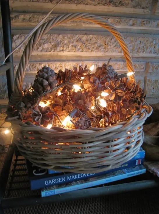 a basket filled with pinecones and lights is a cute and very simple fall or winter decoration