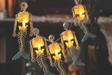 41 a mermaid skeleton garland is a cool solution for Halloween, not only a tropical one