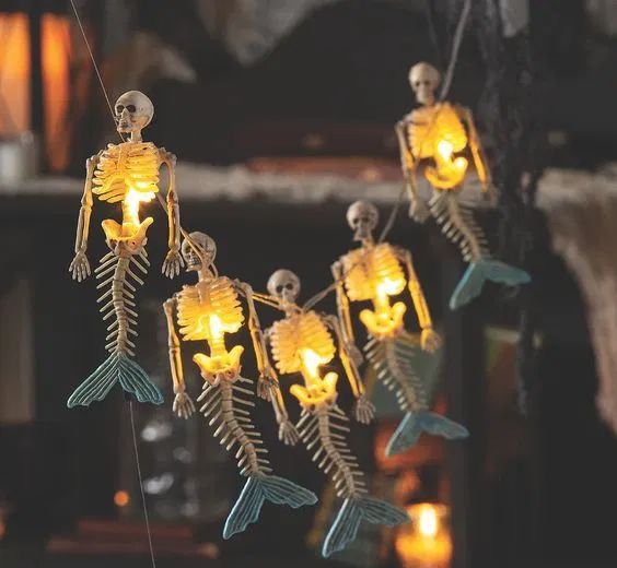 a mermaid skeleton garland is a cool solution for Halloween, not only a tropical one