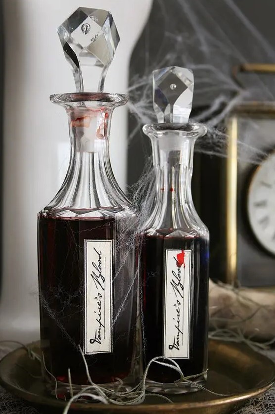 gorgeous idea for Halloween - pour some red wine into elegant bottles and add spooky stickers