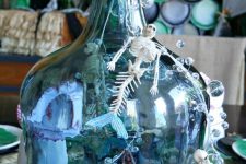 42 a seaside decoration of a large bottle with mermaid skulls, bebbles, greenery and starfish is amazing for Halloween