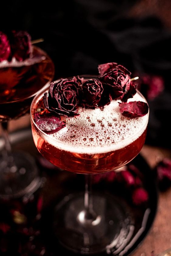 gorgeous red Halloween cocktails topped with dried red roses are perfect for a party, they look refined
