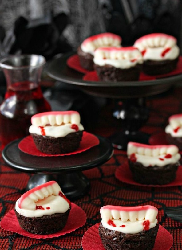 Halloween cupcakes topped with edible vampire teeth are a cool and fun Halloween dessert idea