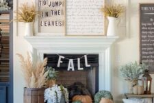 43 fall fireplace styling with a tray with heirloom pumpkins, blooms and wheat in a wooden bucket plus wheat in jugs on the mantel
