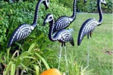 44 black skeleton flamingos and a pumpkin will make your Halloween bold