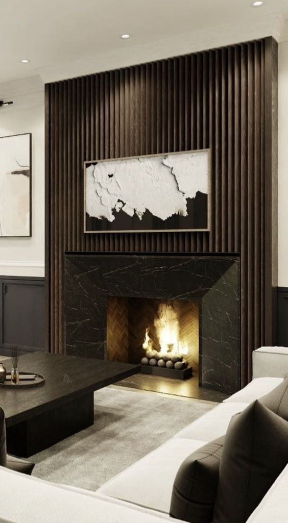 a refined contemporary living room with a fireplace with a black marble surround and a fluted one, dark and white furniture