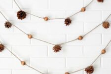 46 a lovely fall garland with pinecones and wooden beads is a cool and all-natural decoration for a fall space