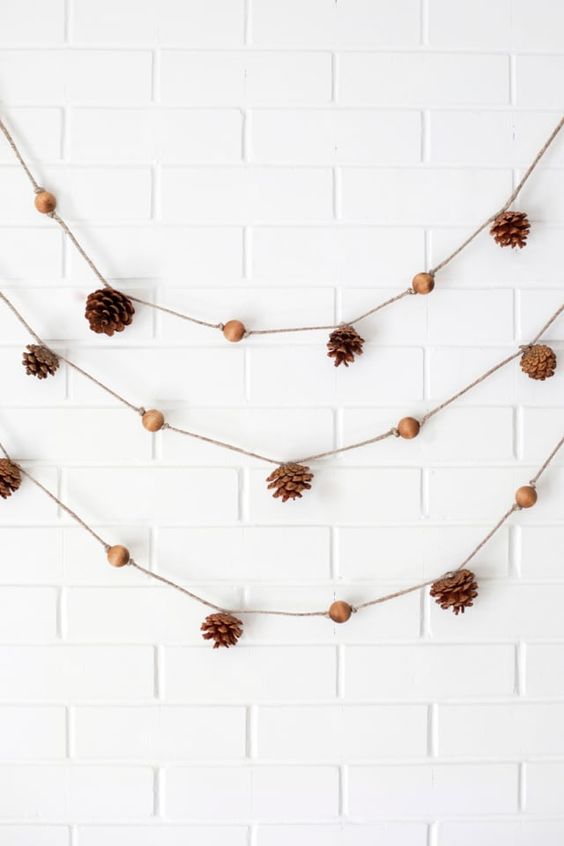a lovely fall garland with pinecones and wooden beads is a cool and all natural decoration for a fall space