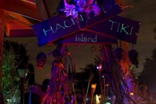 46 dark Halloween decor with a tropical feel, with neon signs, bold bloo,s and leaves and skulls hanging down
