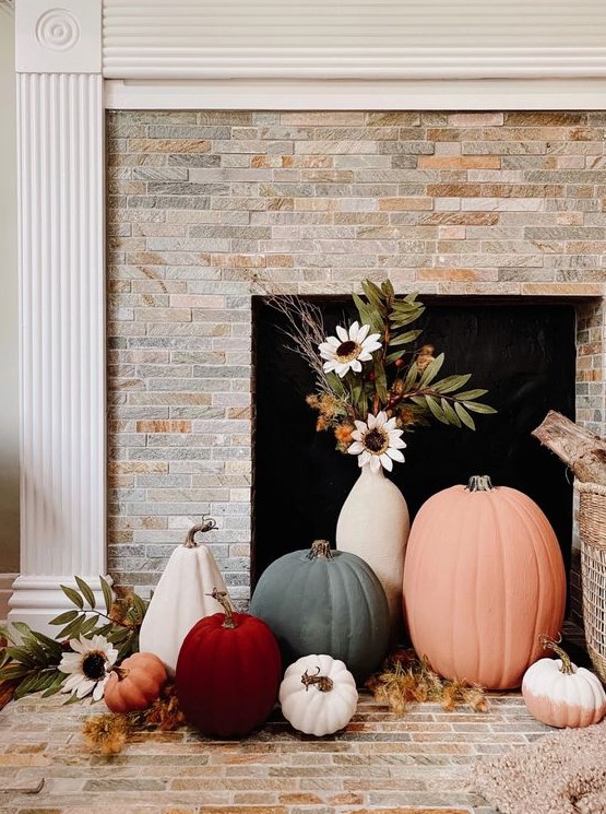 lovely fall fireplace styling with colorful pumpkins and a vase with faux blooms is an easy and lovely idea