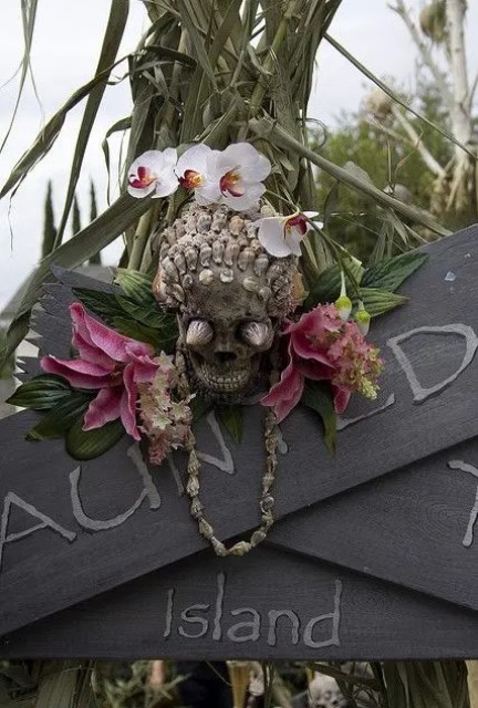 a shell decorated skull with tropical flowers for outdoor and indoor decor at a tropical party