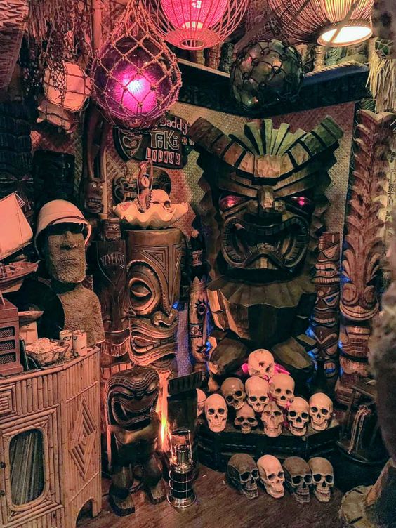 spectacular tropical Halloween decor with skulls, statues, lights and lanterns is cool