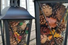 51 black metal lanterns with pinecones and colorful berries are great for fall and can be nice for winter, too
