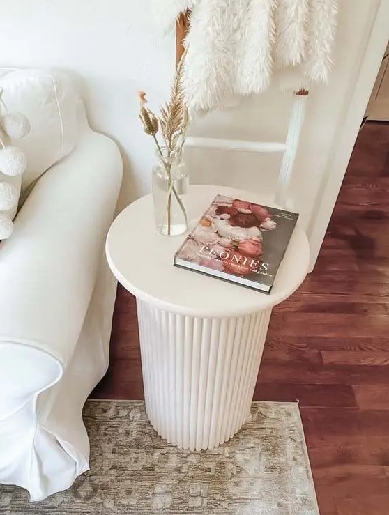 a white side table with a fluted base is a cool solution for a modern or Scandinavian living room, you can DIY one