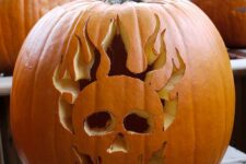 a Halloween pumpkin carved with a skull and flames is a cool solution that won’t take much effort to realize