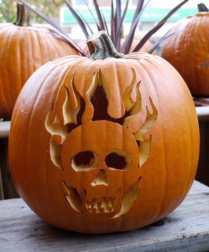 a Halloween pumpkin carved with a skull and flames is a cool solution that won't take much effort to realize
